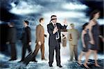 Mature businessman in a blindfold against stormy dark sky with lightning bolts