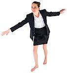 Businesswoman performing a balancing act on white background