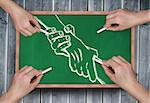 Composite image of multiple hands drawing handshake with chalk on wooden board