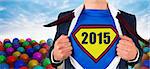 Businessman opening shirt in superhero style against many colourful balloons against sky