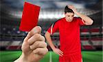 Hand holding up red card against stadium full of usa football fans with player