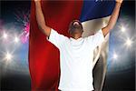 Excited handsome football fan cheering against fireworks exploding over football stadium and chile flag