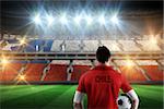 Chile football player holding ball against stadium full of chile football fans