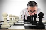 Composite image of focused businessman with chessboard