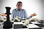 Composite image of young businessman shrugging shoulders with chessboard