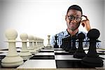 Composite image of confused casual businessman with chessboard