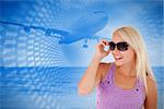 Blond woman with sunglasses against beach scene