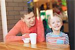 family of two enjoying time together in cafe