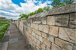 View down old English city wall with cloudy sky background