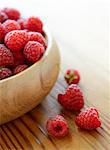 Ripe Red Juicy Raspberries in the Wooden Bowl on the Wooden Table