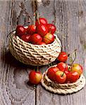 Sweet Maraschino Cherries in Two Wicker Bowls on Rustic Wooden background
