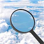 Magnifying glass looking sky in background. View from above the clouds
