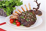 rack of lamb with tomatoes on the table still life