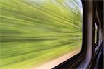 blurred abstract green landscape seen from a  train window in  motion - summer in Missouri