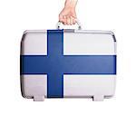 Used plastic suitcase with stains and scratches, printed with flag, Finland