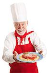 Italian chef holding a plate of spaghetti marinara over white background.