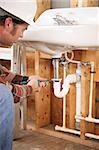 Construction plumber instaling a sink in a new building or renovation.