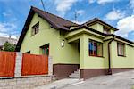 repaired rural house, fixed facade, insulation and painted to green  color