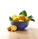 Whole Lemons in Blue Bowl on Countertop, Studio Shot
