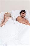 Young couple avoiding each other in bed