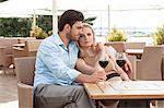 Loving young couple having red wine at outdoor restaurant