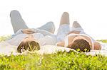 Young couple lying on picnic blanket in park