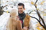 Young man looking at woman in park during autumn