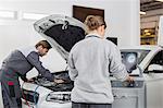 Automobile mechanics working in automobile repair shop