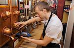 Side view of salesperson dispensing coffee beans into bowl at store