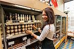 Portrait of smiling saleswoman arranding products in supermarket