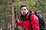 Young male backpacker in forest