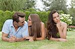 Loving young couple ignoring female friend in park