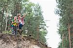 Hiking couple with map discussing over direction in forest