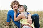 Happy loving couple relaxing in field