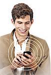 Smiling young businessman using cell phone over white background