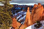 Hoodoos strongly lit by early morning sun with heavy cloud, Peekaboo Loop Trail in winter, Bryce Canyon National Park, Utah, United States of America, North America