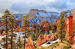 Hoodoos strongly lit by early morning sun with heavy cloud, Peekaboo Loop Trail in winter, Bryce Canyon National Park, Utah, United States of America, North America