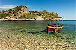 Excursion boat moored on pretty Isola Bella Bay in this popular northeast tourist town, Taormina, Catania Province, Sicily, Italy, Mediterranean, Europe