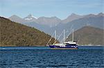 Fiordland Navigator cruise boat and Coronation Peak, Doubtful Sound, Fiordland National Park, UNESCO World Heritage  Site, South Island, New Zealand, Pacific