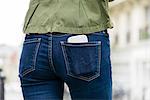 Woman carrying smartphone in back pocket
