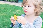 Little girl eating macaroon