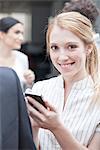 Businesswoman checking smartphone on the move