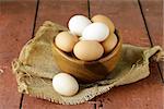 natural organic eggs in a wooden bowl