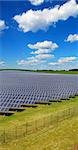 solar power station under blue sky, panels producing electricity