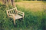 Bamboo wooden chairs on grass field in countryside Thailand vintage