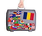 Used plastic suitcase with lots of small stickers, large sticker of Romania