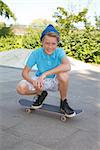 Cool young boy outdoor with skateboard