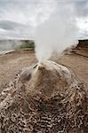 Fumarole in the geothermal area Hveravellir, central Iceland. The area around is layered and cracked.