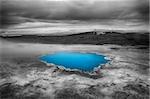 Incredibly blue pool Blahver at Hveravellir is actually a hot geothermal spring in the heart of Iceland. Photo taken around midnight with a storm coming