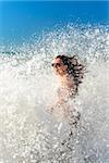 Girl bathes in a storm at sea, a wave washed over